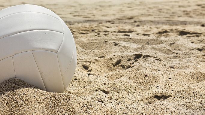 White,Volleyball,Sits,On,Top,Of,The,Sand.