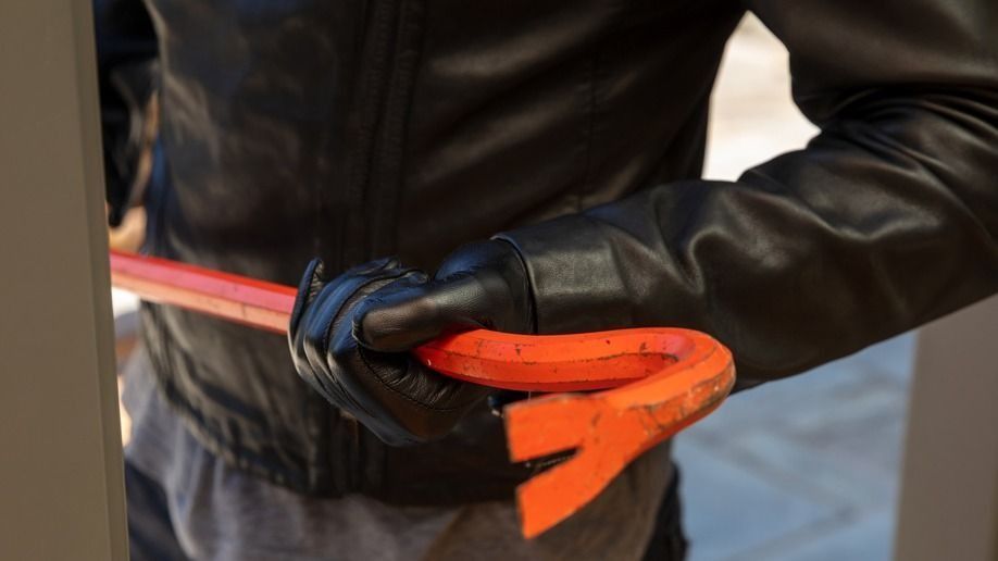 Burglar,In,Leather,Jacket,Breaking,A,Glass,Aluminum,Door.,Masked