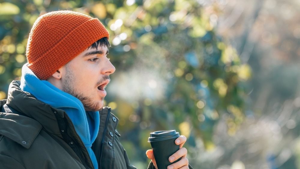 Young,Man,Wrapped,Up,In,Winter,Breathing,Halo,Of,Cold