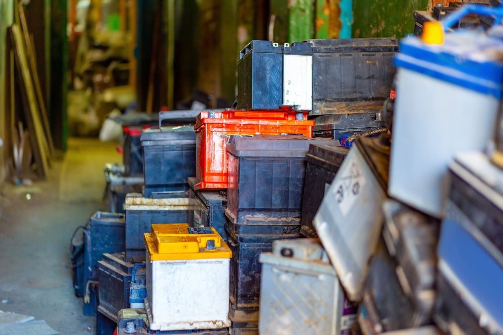 Discarded,Old,Car,Batteries,In,A,Garage,For,Recycling,In