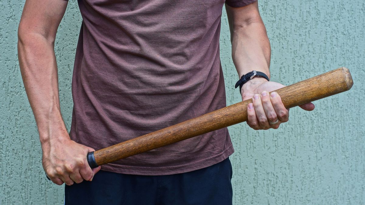 Wooden,Bat,In,The,Hands,Of,A,Man,In,Brown