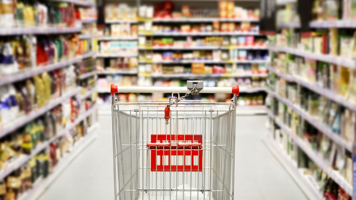 choosing a dairy products at supermarket.empty grocery cart in an empty supermarket