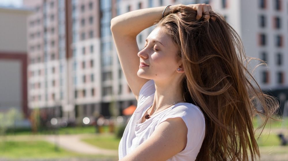 Positive,Young,Attractive,Woman,With,Loose,Hair,In,A,White